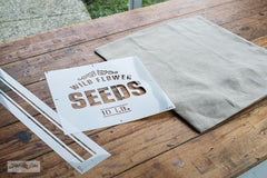 Make a vintage-inspired Wild Flower Seeds pillow with a 20" Ikea pillow cover, plus Wild Flower Seeds and Grain Sack Stripe G4L stencils from Funky Junk's Old Sign Stencils!