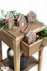 Create a dreamy holiday scene with the Gingerbread Village stencil! Included are three charming gingerbread houses with hand-drawn icing details. Included is a sky scene if stenciling on a flat surface, or use the additional stencil pieces designed to fit perfectly on cut 2x4s to create 3D houses.&nbsp;

Or choose one of our two custom MDF wood kits to either create ornaments and a banner or a standing village!