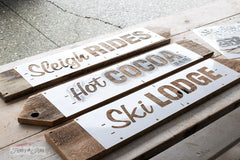 Winter directional signs made with Sleigh Rides from Funky Junk's Old Sign Stencils. Create professional painted winter themed sleigh styled signs onto reclaimed wood in minutes with this festive, wintery stencil design!