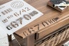 Get the look of a pallet by stenciling Pallet Stamps on your wooden projects! This Ikea hacked table shows you how. By Funky Junk's Old Sign Stencils.